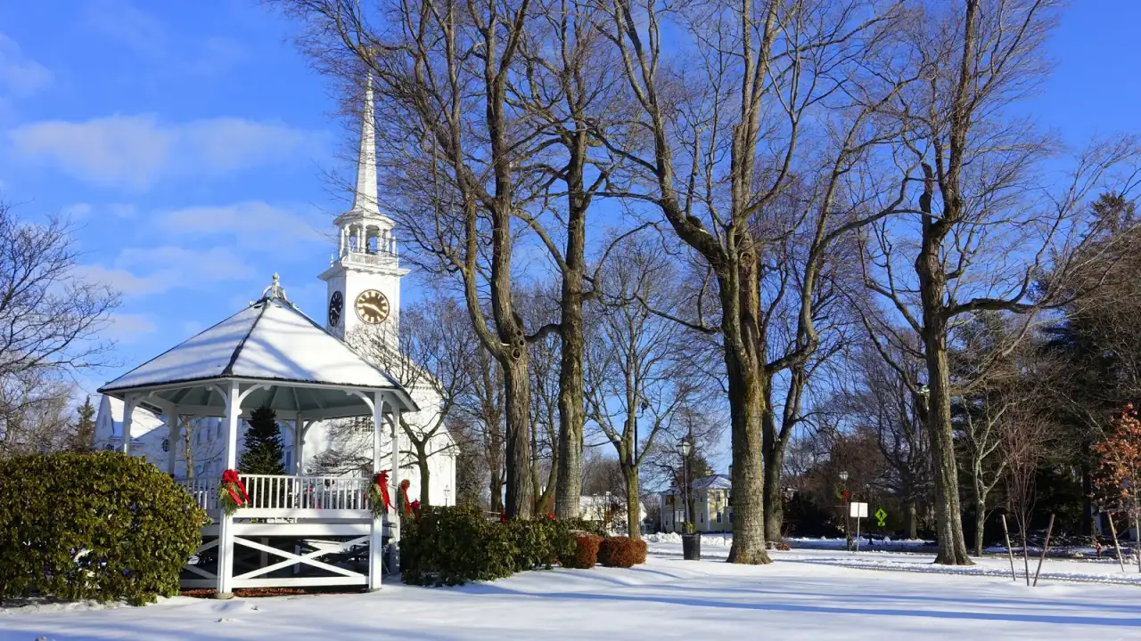 Snow-covered town common with a white gazebo and church steeple, Shrewsbury, Massachusetts